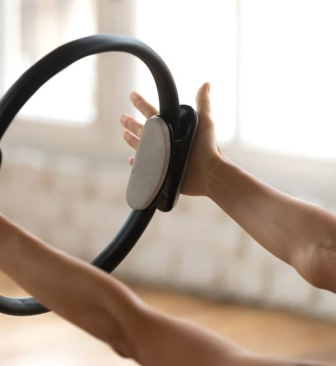 Pilates Instructor exercising with pilates ring